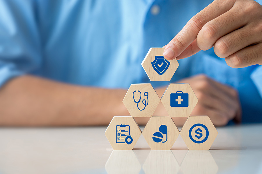 Stacked building blocks with medical icons representing medicare options