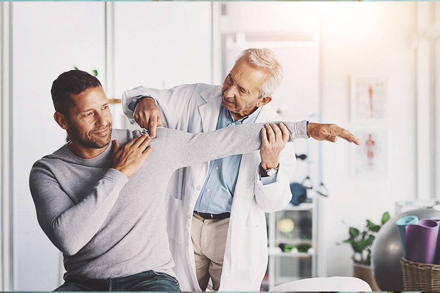 Doctor and patient accessing shoulder injury