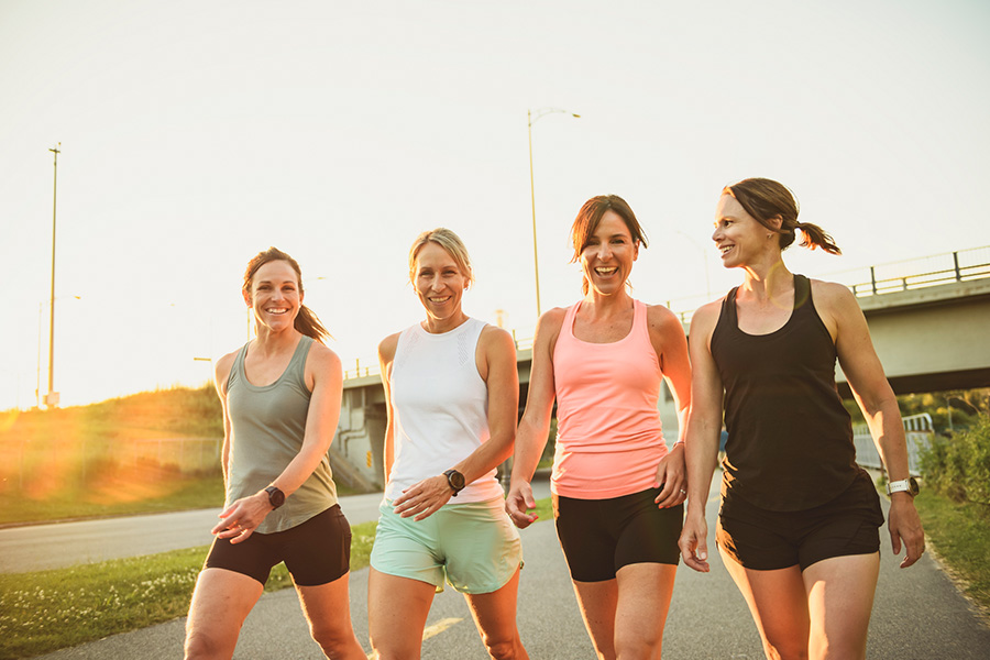 Four women walking in exercise clothes